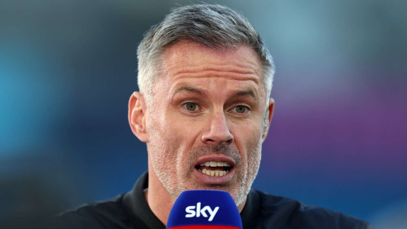 Man speaking into a blue microphone labeled Sky during an interview or press event