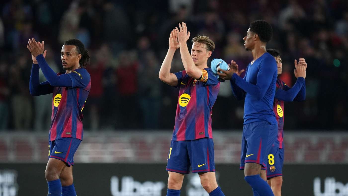 Three FC Barcelona players in blue and maroon striped kits clap on the pitch after a play or during a celebration